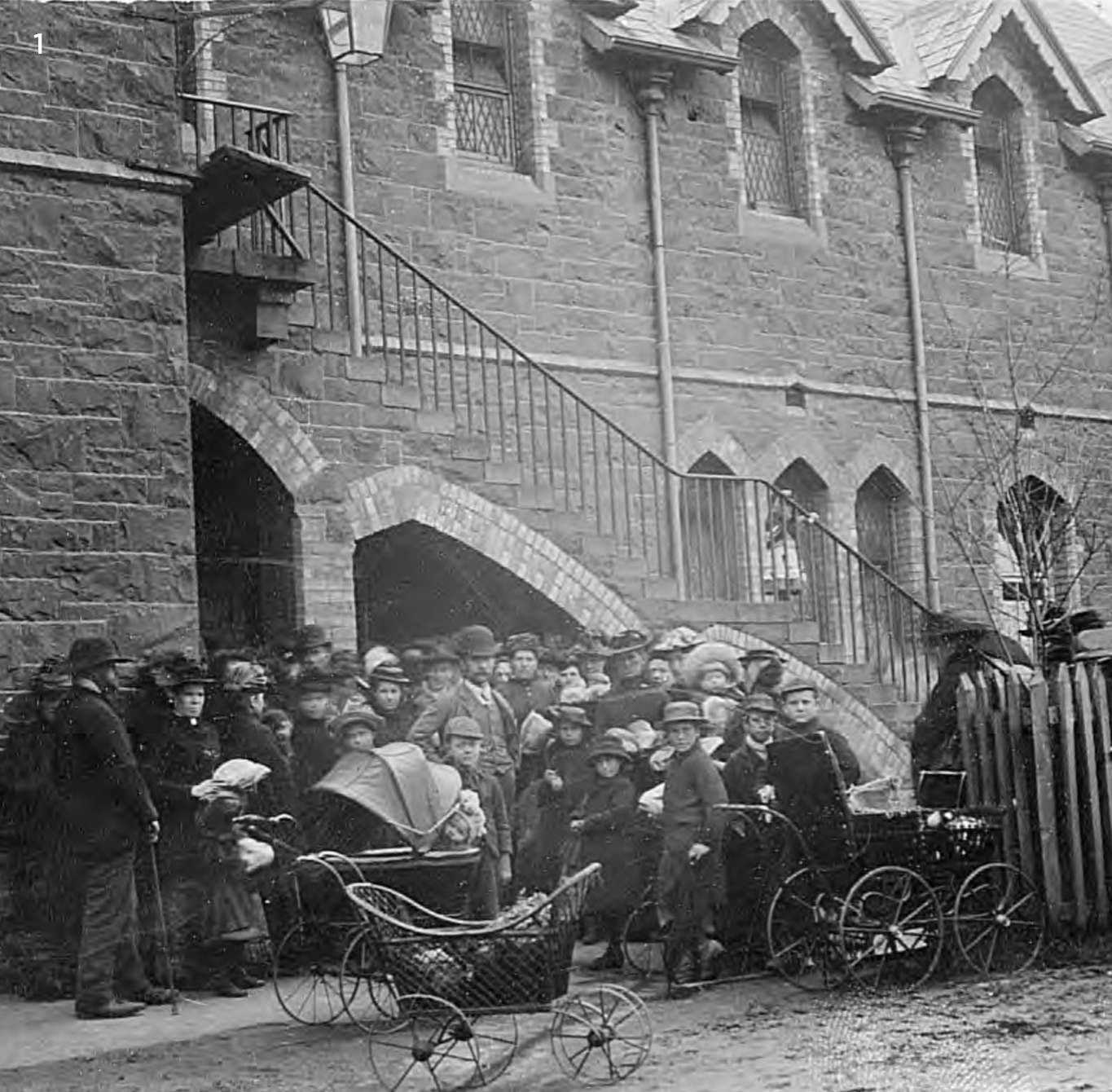 Local residents queuing for relief outside the School House, 1890s.
